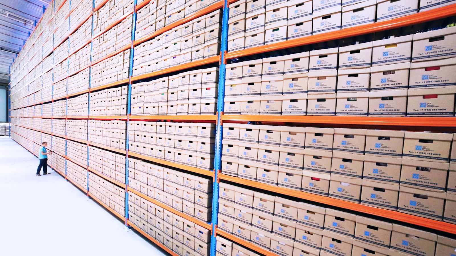 Rows of archived document boxes on warehouse shelving