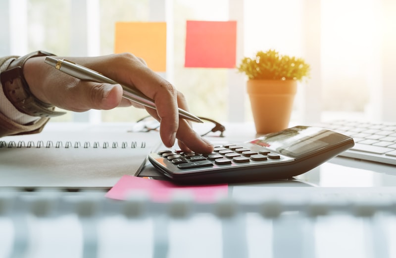 A calculator and financial figures on a desk