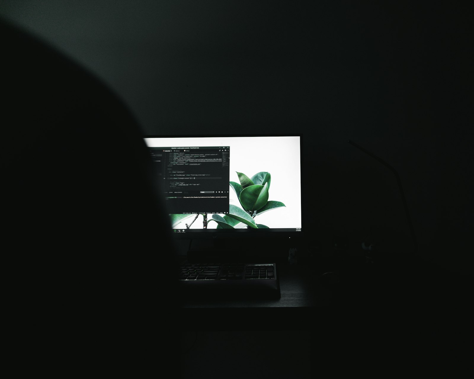 A monitor showing code in a dark room