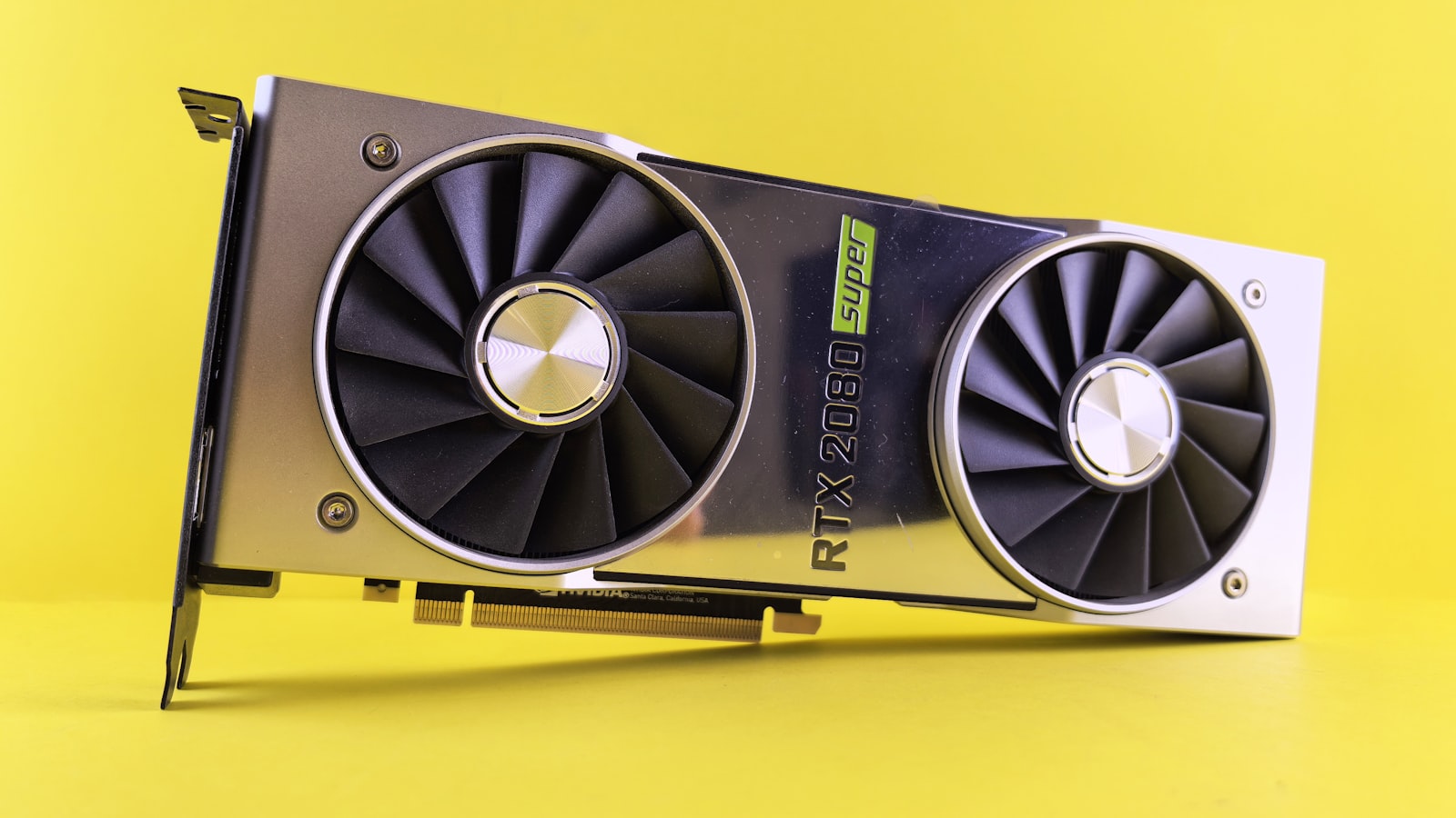 An NVIDIA GPU graphics card on a bright yellow background